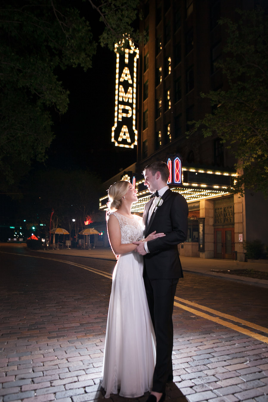 Downtown Tampa Bride and Groom Wedding Portrait In Front of The Tampa Theatre Lighted Sign | Tampa Wedding Photographer Carrie Wildes Photography