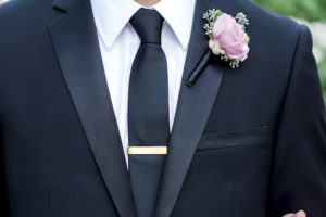 Groom Wedding Portrait in Black Tuxedo with Gold Tie Clip and Blush Pink Boutonnière