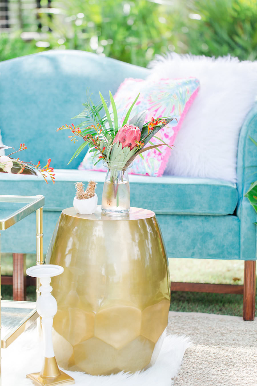 Teal Vintage Couch Wedding Seating Ideas and Inspiration with Eclectic End Tables and Tropical Wedding Centerpieces with Lilly Pulitzer Accents | Tampa Bay Vintage Wedding Rental Furniture The Reserve Vintage Rentals