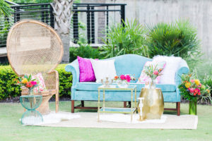 Teal Vintage Couch and Ratan Chair Wedding Seating Ideas and Inspiration with Eclectic End Tables and Tropical Wedding Centerpieces with Lilly Pulitzer Accents | Tampa Bay Vintage Wedding Rental Furniture The Reserve Vintage Rentals