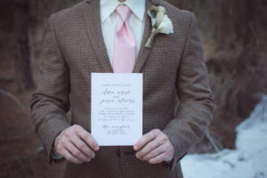 Groomsmen Portrait in Brown Plaid Suit Holding Wedding Invitation