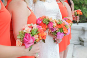 Bridal Wedding Portrait in Long Sleeve Lace Wedding Dress with Bridesmaids in Bright Orange Tea Length Dresses and Vibrant Pink, Orange and Green Wedding Bouquets | Tampa Bay Wedding Florist Apple Blossoms Floral Design