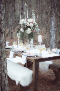 Outdoor Winter Inspired Wedding Reception with Faux Fur and Wooden Farm Tables with Tall Blush Pink and Ivory Floral Centerpieces | Ever After Vintage Weddings Tampa Bay Wedding Rental Company and Event Stylist