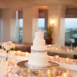Four Tiered white Wedding Cake on Large Silver Cake Stand with Embellished Design | Tampa Wedding Cake Bakery A Piece of Cake and Desserts