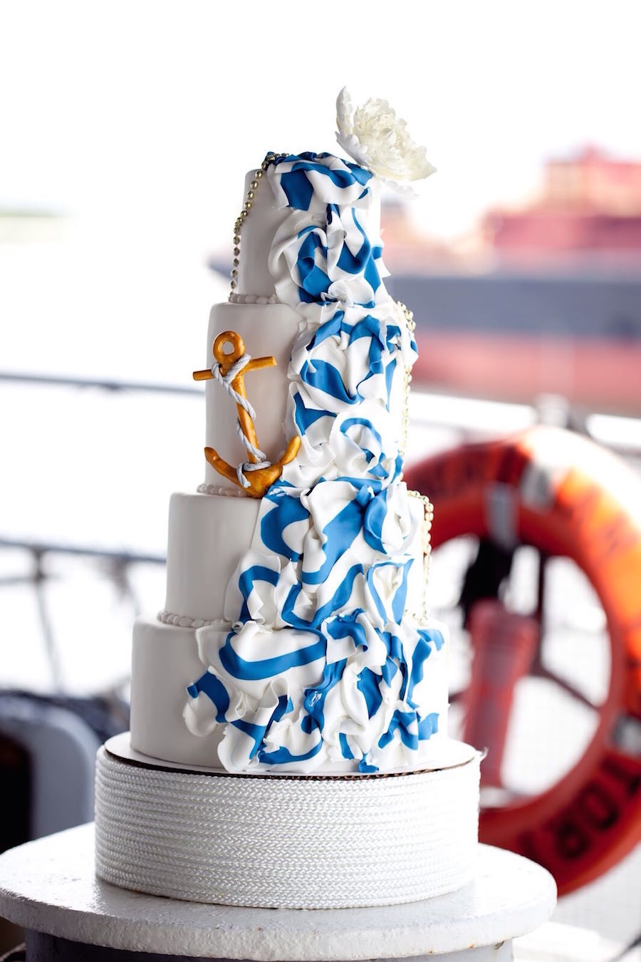 Four Tiered Nautical Inspired Wedding Cake with Anchor and Flag Accent | Tampa Wedding Cake Bakery A Piece of Cake and Desserts