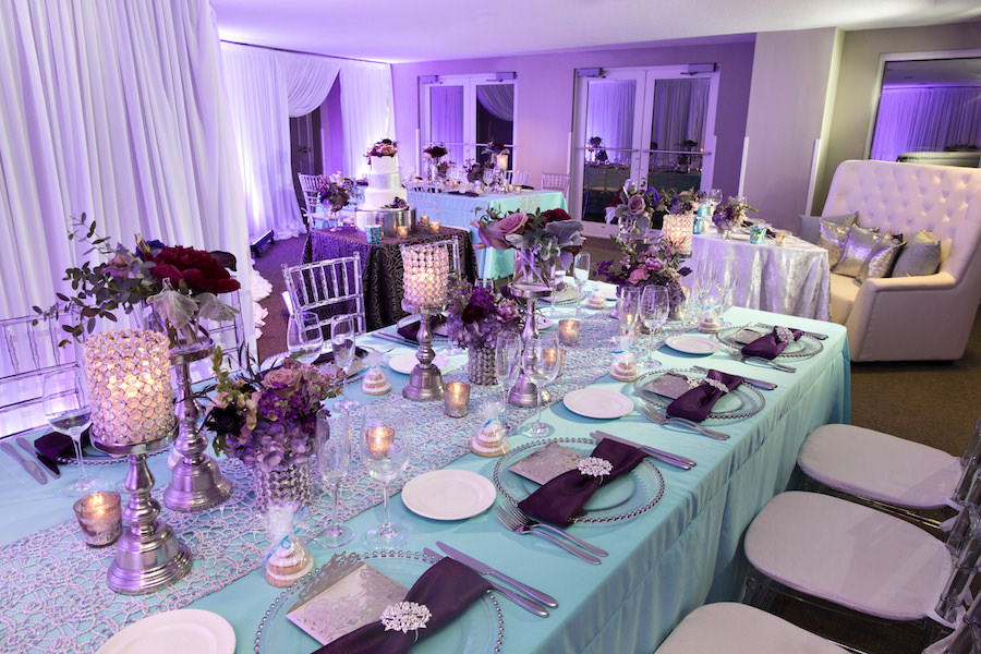 Beaded Glass Charger with Silver Wedding Menu and Purple Napkin with Rhinestone Holder | Purple and Deep Red Centerpieces with Candles on Tiffany Blue Linens with Clear Chiavari Chairs | Wedding Reception Ideas & Inspiration | Special Moments Event Planning | Connie Duglin Linens | Gabro Event Services