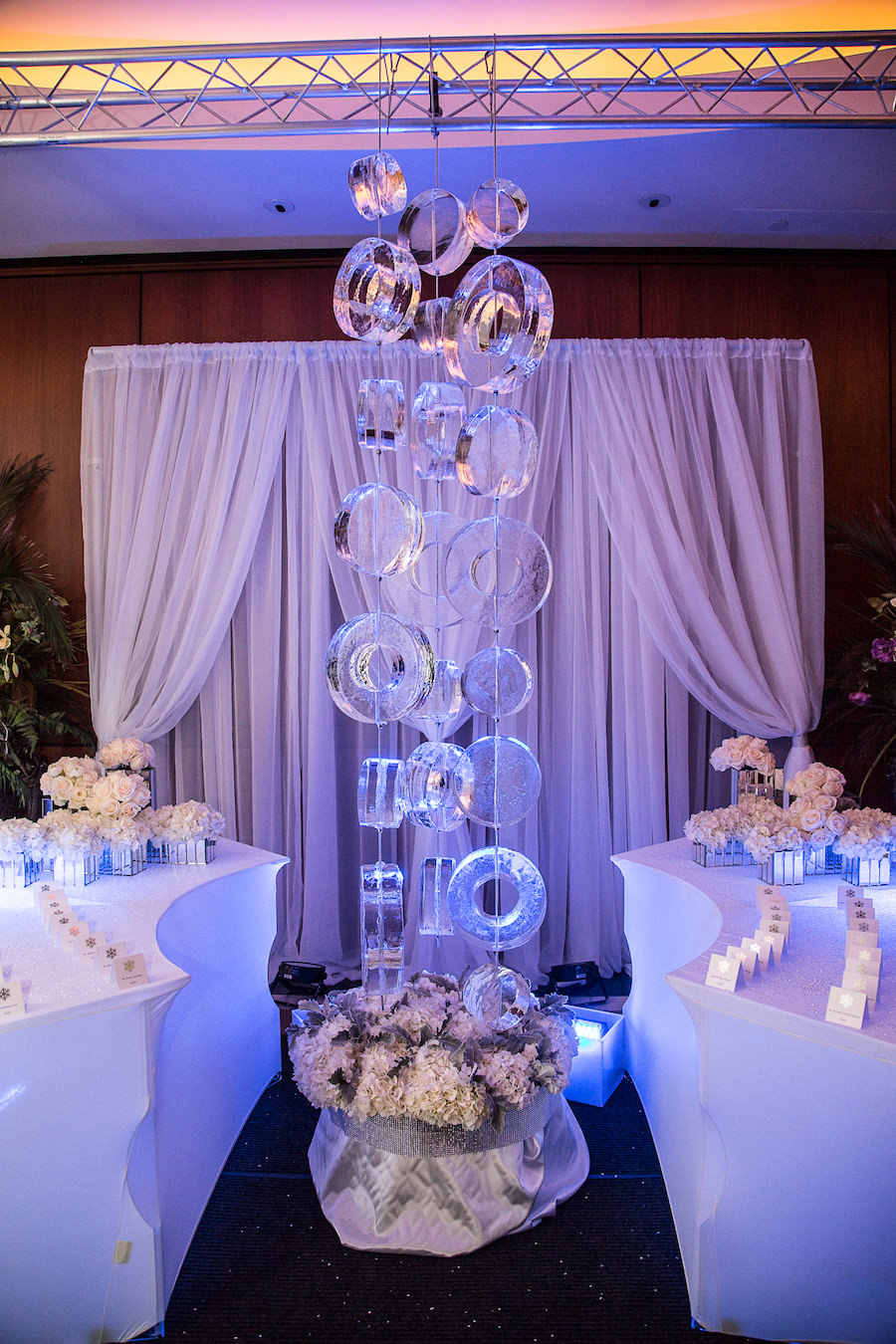 Indoor, Winter Wonderland Wedding Reception Decor with Ice Sculpture, Draping and Ivory Floral Decor | Tampa Wedding Planner UNIQUE Weddings and Events