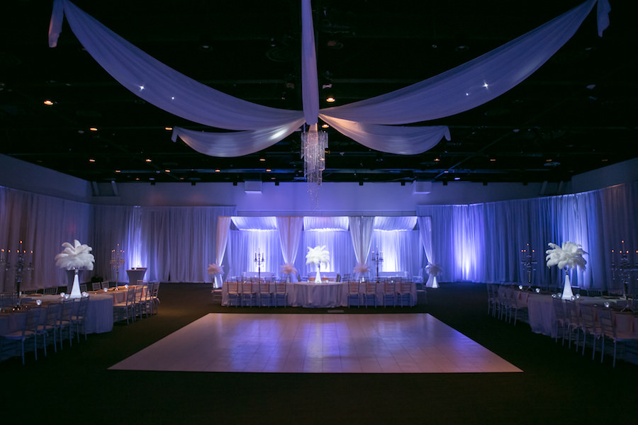 Purple Uplighting and Pin-spotting Lighting Effects for Florida Modern Wedding Reception with Drapery and Chiavari Chairs with Feather Decor by Tampa Event Rental Company Gabro Event Services