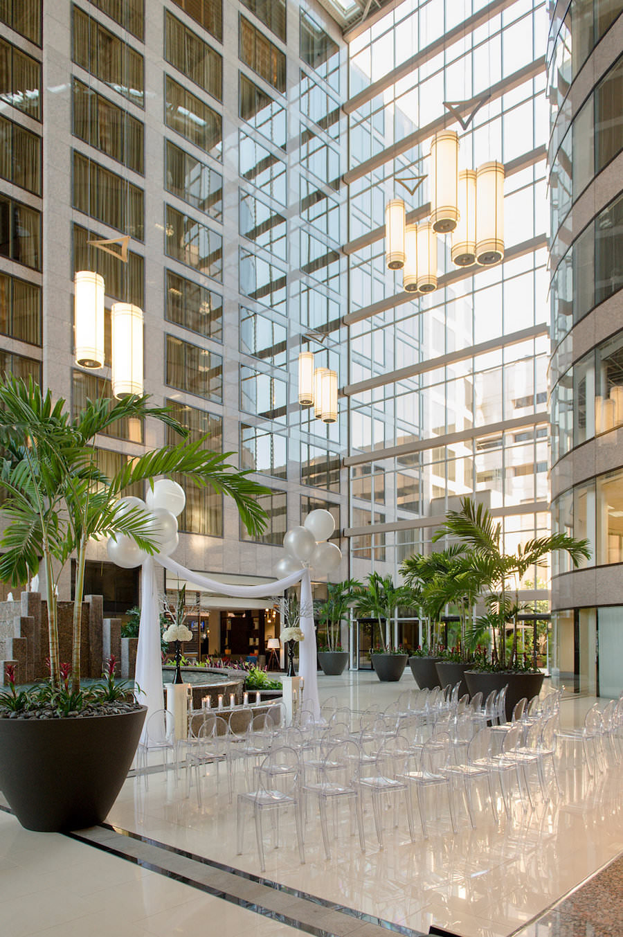 Modern Wedding Ceremony with Ghost Chairs and Large Balloons with Drapery | Modern Tampa Wedding Venue Centre Club Tampa