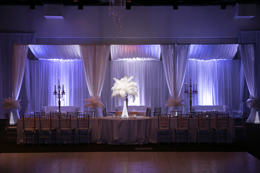 Purple Uplighting and Pin-spotting Lighting Effects for Florida Modern Wedding Reception with Drapery and Chiavari Chairs with Feather Decor by Tampa Event Rental Company Gabro Event Services