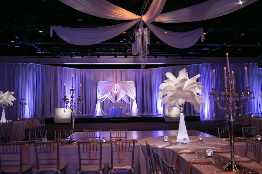 Purple Uplighting and Pin-spotting Lighting Effects for Florida Modern Wedding Reception with Drapery and Chiavari Chairs with Feather Decor by Tampa Event Rental Company Gabro Event Services