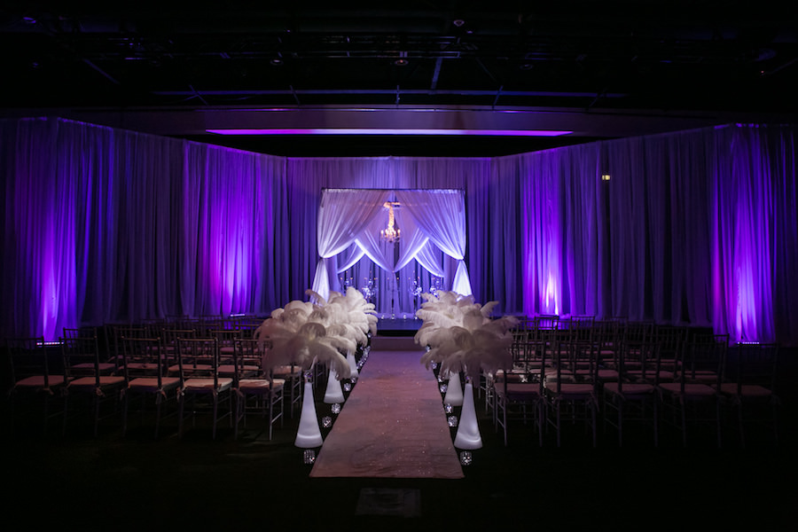 Purple Uplighting and Pin-spotting Lighting Effects for Florida Modern Wedding Ceremony with Drapery and Chiavari Chairs with Feather Aisle Decor by Tampa Event Rental Company Gabro Event Services