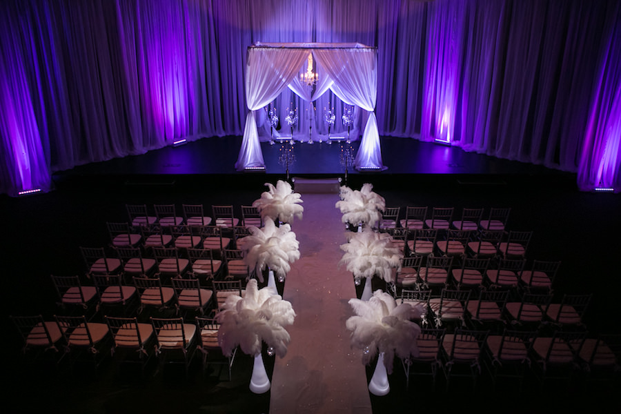 Purple Uplighting and Pin-spotting Lighting Effects for Florida Modern Wedding Ceremony with Drapery and Chiavari Chairs with Feather Aisle Decor by Tampa Event Rental Company Gabro Event Services