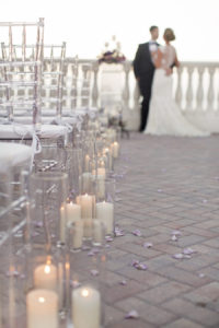 Candlelit Ceremony Aisle with Purple Rose Petals and Clear Chiavari Chairs | Clearwater Beach Wedding Venue Hyatt Regency | Wedding Planner Special Moments Event Planning | Chair Rentals Gabro Event Services