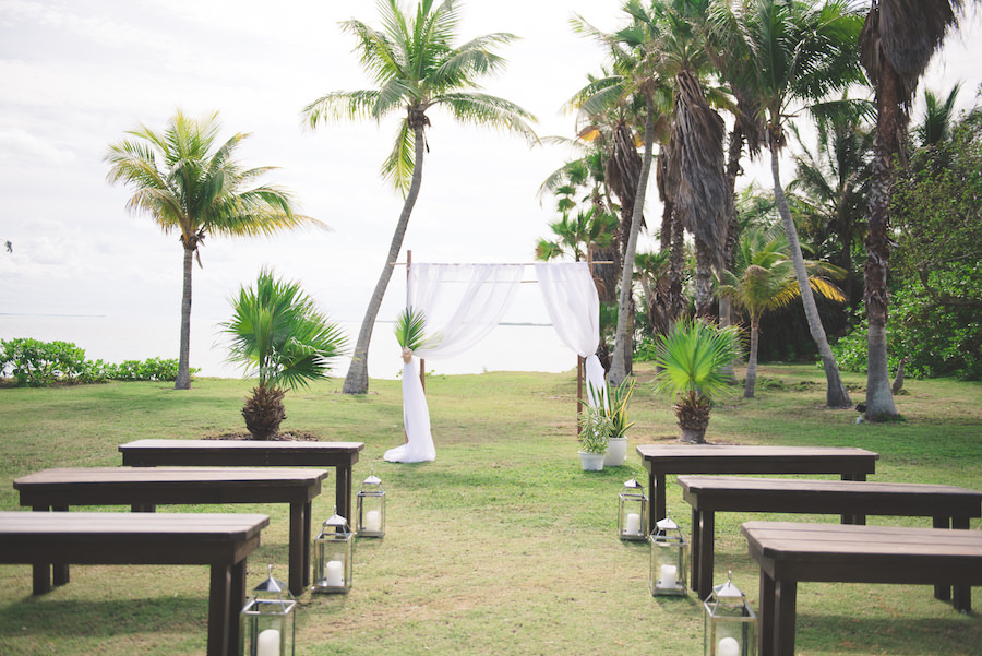 Bahamas Destination Beach Caribbean Lawn Grass Ceremony Venue with Bamboo Arch and Wooden Benches | Aisle Society Weddings Abaco Beach Resort