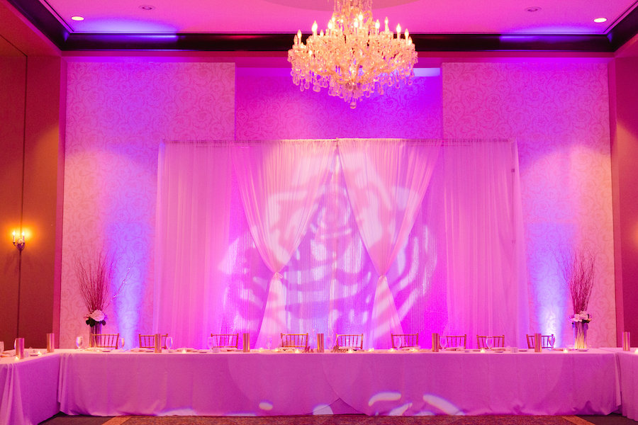 Elegant Ballroom Wedding Reception with Purple Uplighting, Chandelier and Head Bridal Party Table | | Tampa Country Club Wedding Venue The Palmetto Club