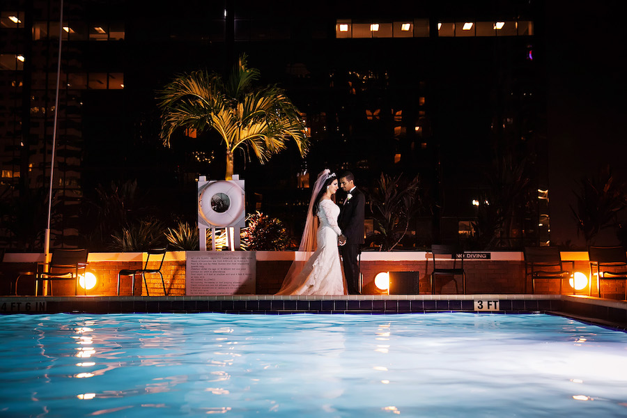 Outdoor, Nighttime, Bride and Groom Portrait by Rooftop Pool | Downtown Tampa Hotel Wedding Venue Hilton Downtown | Wedding Photographer Limelight Photography