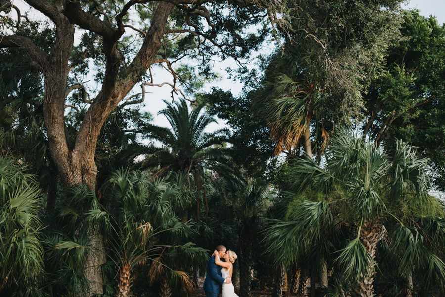 Outdoor, Bride and Groom Wedding Portrait Kissing with Tall Palm Trees in Nature | Sarasota Wedding Venue Powel Crosley Estate