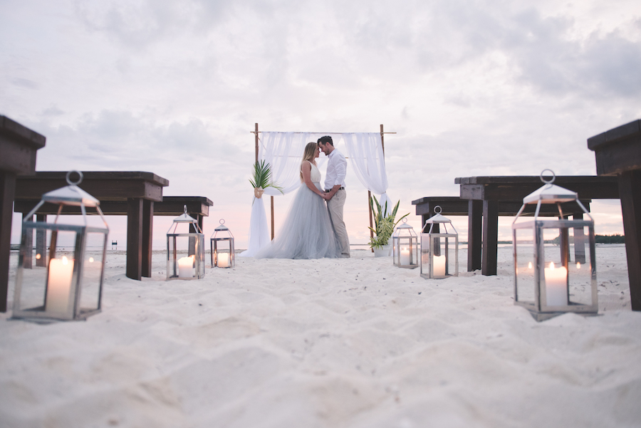 Bahamas Destination Beach Caribbean Ceremony Venue with Bamboo Arch, Silver Lanterns and Wooden Benches | Aisle Society Weddings Abaco Beach Resort
