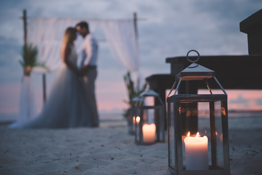 Bahamas Destination Beach Caribbean Sunset Ceremony Venue with Bamboo Arch, Silver Lanterns and Wooden Benches | Aisle Society Weddings Abaco Beach Resort