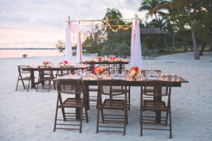 Bahamas Destination Beach Caribbean Reception Venue with Farm Tables, Bamboo Seating and Candlelight | Aisle Society Weddings Abaco Beach Resort