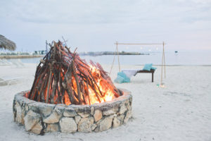 Bahamas Destination Beach Caribbean Wedding Venue Beachside Bonfire and Green Turquoise Lounge Seating | Aisle Society Weddings Abaco Beach Resort