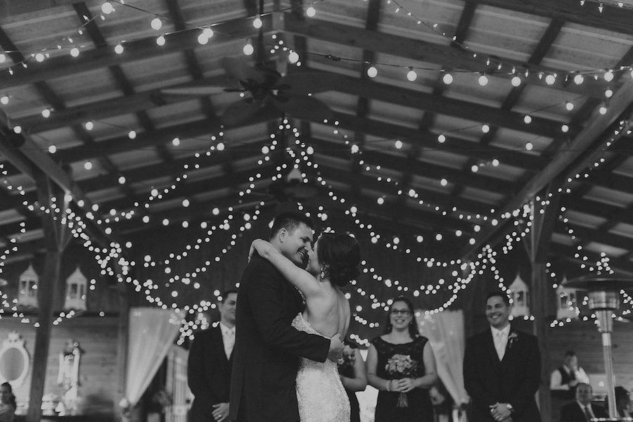 Bride and Groom First Dance Outdoor Barn with Market String Lights Wedding Day Portrait | Rustic Tampa Wedding Reception Venue Cross Creek Ranch