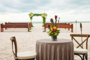 Oceanfront Tampa Bay Wedding Ceremony with Wooden Church Pews and Tropical Palm Bamboo Altar | Waterfront Wedding Venue Hilton Clearwater Beach | Rentals A Chair Affair