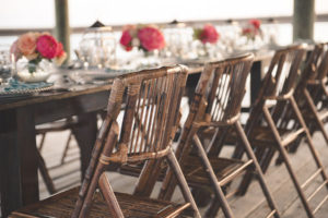 Bahamas Destination Beach Caribbean Reception Venue with Farm Tables and Bamboo Seating | Aisle Society Weddings Abaco Beach Resort