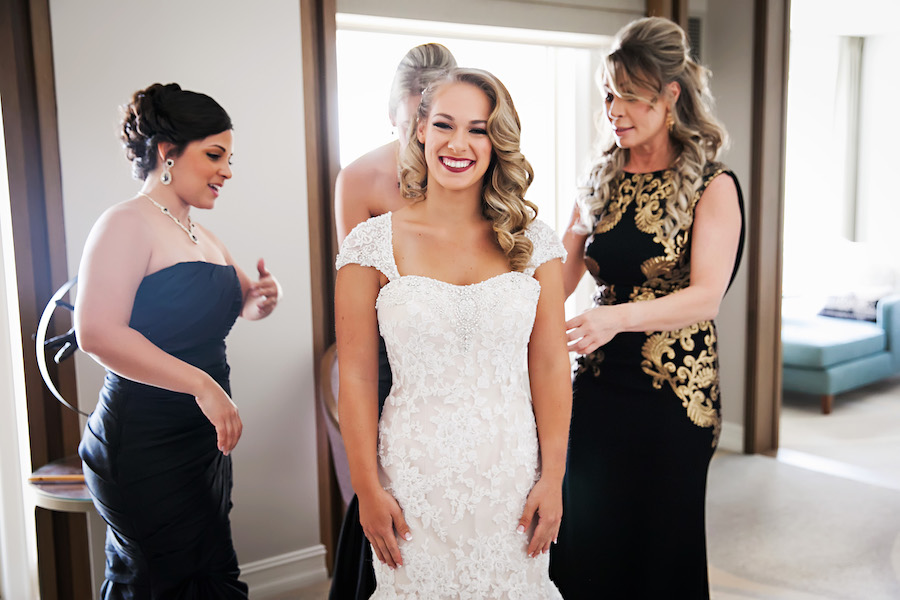 Getting Ready: Bridal Prep Bride Putting on Wedding Dress with Bridesmaids | Sarasota Wedding Photographer Limelight Photography