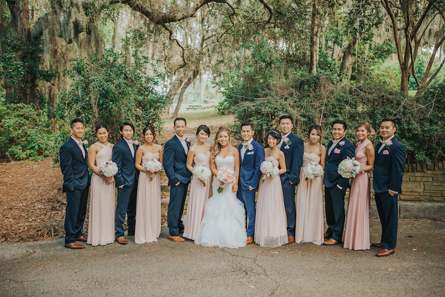 Bridal Party Bridesmaids Portrait in Pink Blush Peach Dresses and Groomsmen in Dark Blue Suits | Tampa Bay Wedding Photographer Rad Red Creative