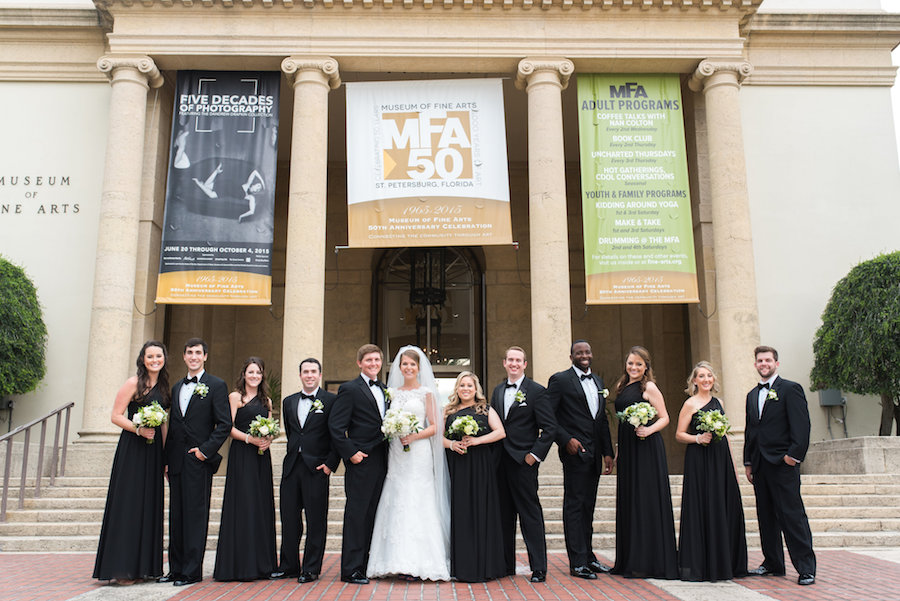 Outdoor Bridal Party Wedding Portrait at Downtown St. Pete Wedding Venue Museum of Fine Arts | Black Bridesmaid Wedding Gowns with Cap Sleeve Lace Alfred Angelo Wedding Dress and Ivory Wedding Bouquet | St. Petersburg Wedding Photographer Caroline and Evan Photography