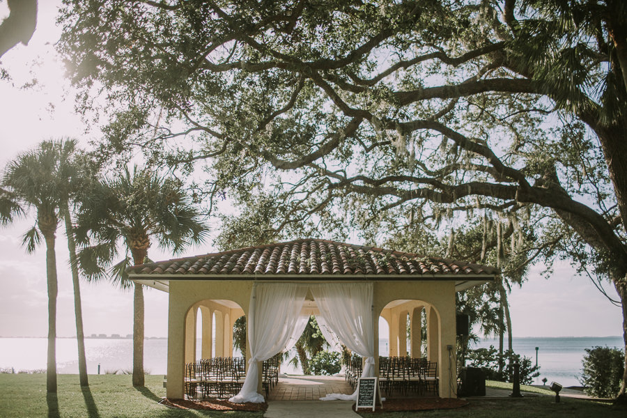 Romantic Outdoor Waterfront Wedding Ceremony with Draping and Brown Chiavari Chairs | Waterfront Sarasota Wedding Venue Powel Crosley Estate