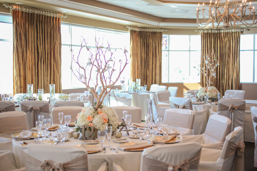 St. Petersburg Reception Decor with Ivory and Coral Floral Centerpieces with Wooden Trees, Gold Chargers, and Tan Chair Bow Sashes | St. Petersburg Wedding Venue Isla Del Sol Yacht and Country Club | St. Pete Rentals Connie Duglin Linens