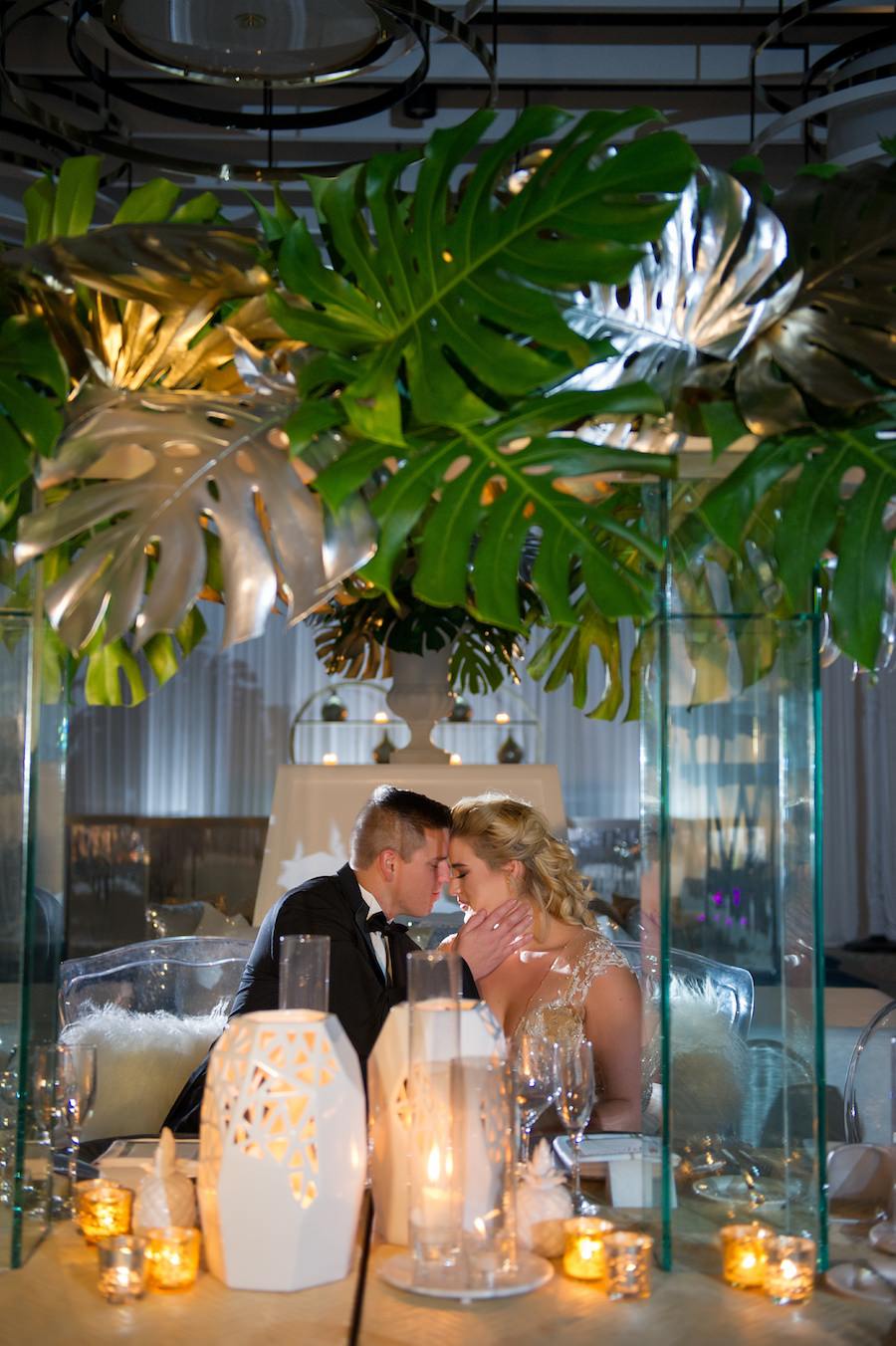 Modern Gold South Beach Inspired Wedding Reception Decor with Tall Palm Leaf Centerpieces, Candles and Gold Linens from Over the Top Linen Rentals | Clearwater Beach Wedding Venue Wyndham Grand | Wedding Planner Parties a la Carte | Andi Diamond Photography