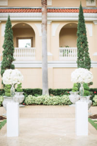Elegant, Outdoor Wedding Ceremony with Tall White Centerpieces on White Pedestals | Sarasota Hotel Garden Wedding Venue Ritz Carlton
