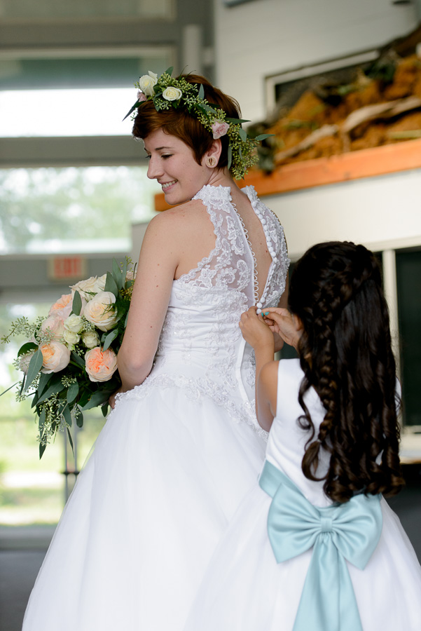 Bride Getting Dressed in White, Tea Length, Lace Wedding Dress and Flower Crown