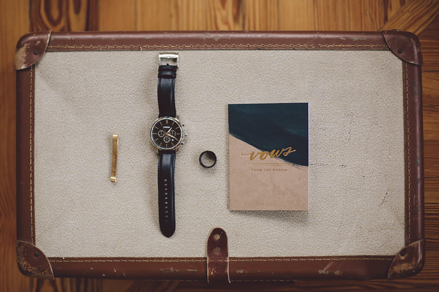 Groom Getting Ready Detail Wedding Portrait with Gold Tie Clip, Leather Watch, Rings and Vow Book