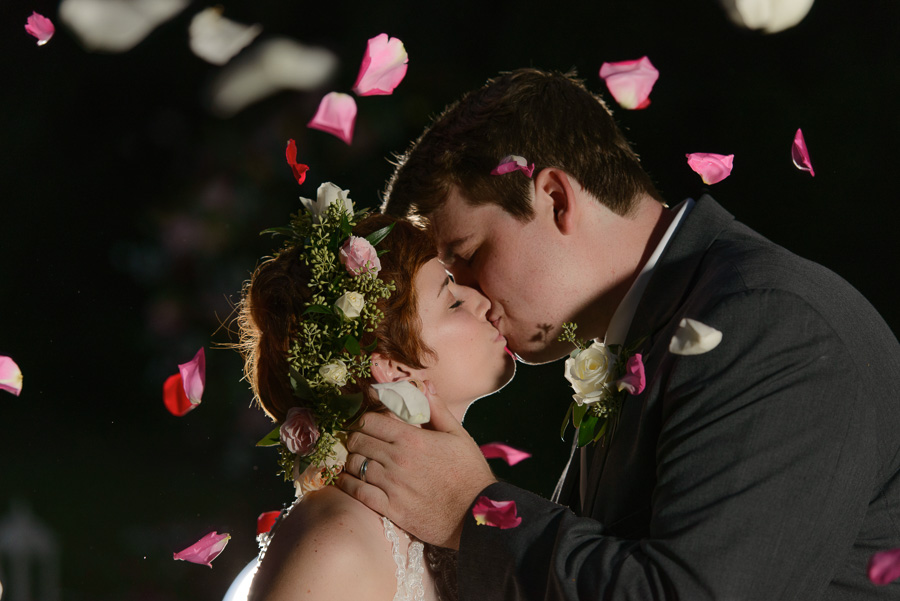 Outdoor, Nighttime, Bride and Groom Wedding Portrait Kissing with Rose Petals at Spring Hill Wedding
