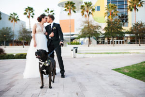Bride and Groom Wedding Portrait With Pet Dog in Tuxedo | Downtown Tampa Wedding Venue The Glazer Children's Museum | Bridal Wedding Dress Shop Isabel O'Neil Bridal | Wedding Photographer Limelight Photography | Pet Planning Sitter Services Fairytail Petcare