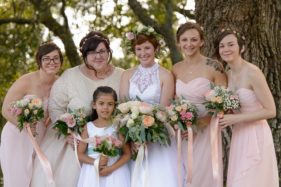 Bride and Bridesmaids in Blush Bridesmaids Dresses and Peach and Pink Floral Bouquets