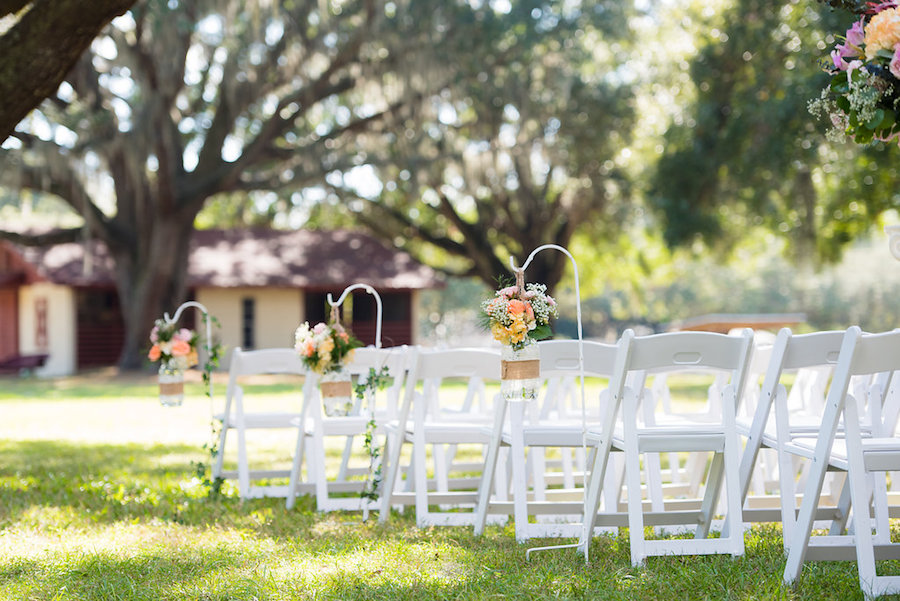 Wooden Ceremony Folding Chairs wth Mason Jar Floral Aisle Decor | Outdoor Private Estate Wedding Venue in Brandon Florida |Tampa Bay Florida Wedding Venue Casa Lantana