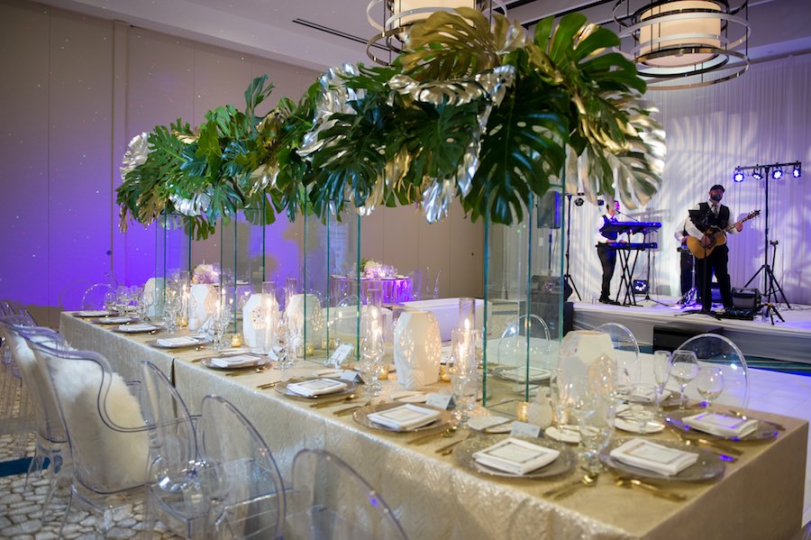 Modern Gold South Beach Inspired Wedding Reception Decor with Ghost Chairs from A Chair Affair, Tall Palm Leaf Centerpieces and Gold Linens from Over the Top Linen Rentals | Clearwater Beach Wedding Venue Wyndham Grand | Wedding Planner Parties a la Carte