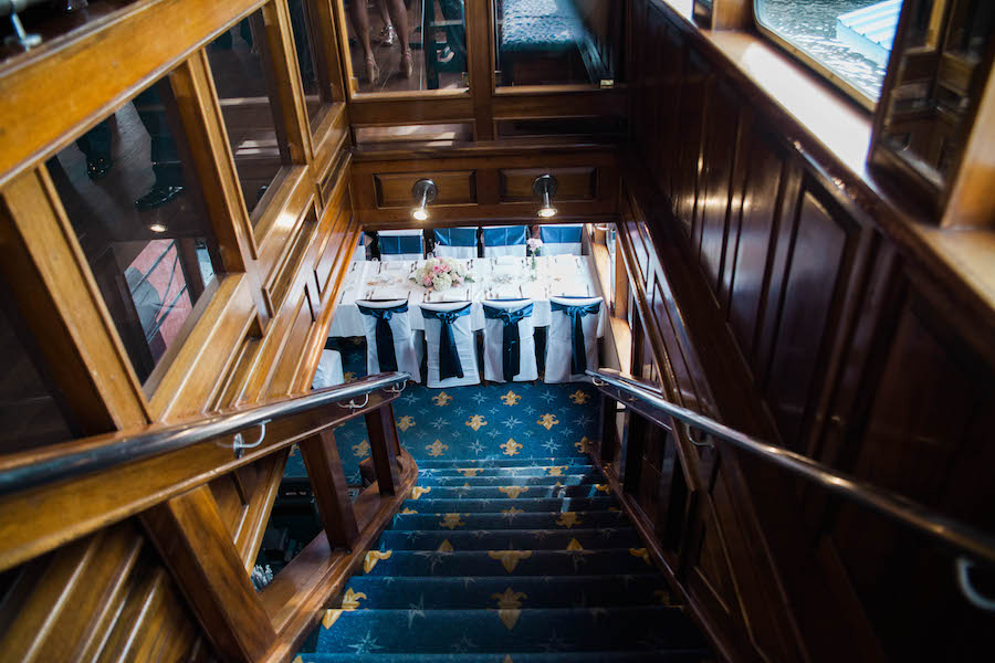 Navy and Nautical, Tampa Unique Waterfront Wedding Reception with White Chair Covers and Navy Chair Bows | Unique Waterfront Tampa Wedding Venue Yacht Starship