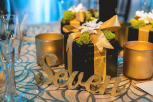 Ballroom Tampa Bay Indoor Wedding Reception with Gold Table Numbers and Low Centerpieces with Moss | Waterfront Wedding Venue Hyatt Regency Clearwater Beach | Wedding Planner Special Moments Event Planning | Apple Blossom Floral Designs