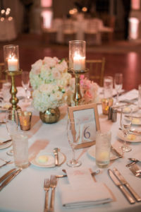 White Hydrangea and Blush Pink Rose Centerpiece Flowers with Tall Candles and Gold Chiavari Chairs | Wedding Reception Decor Inspiration
