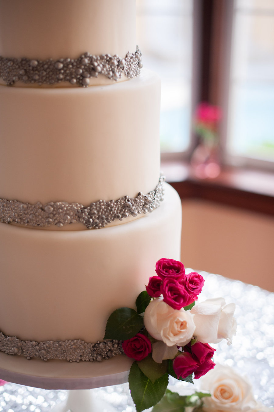 Three Tiered, White, Round Wedding Cake with Silver Accents and Ivory and Pink Flowers