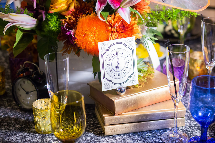 Alice in Wonderland Themed Whimsical Fairytale Wedding Reception Decor with Clock and Vintage Book Centerpieces with Multicolor Glasses | St. Petersburg Wedding Planner UNIQUE Weddings & Events