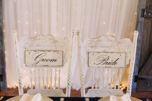 Bride and Groom Sweetheart Table Signs and White, Whitewashed Distressed Wooden Chairs