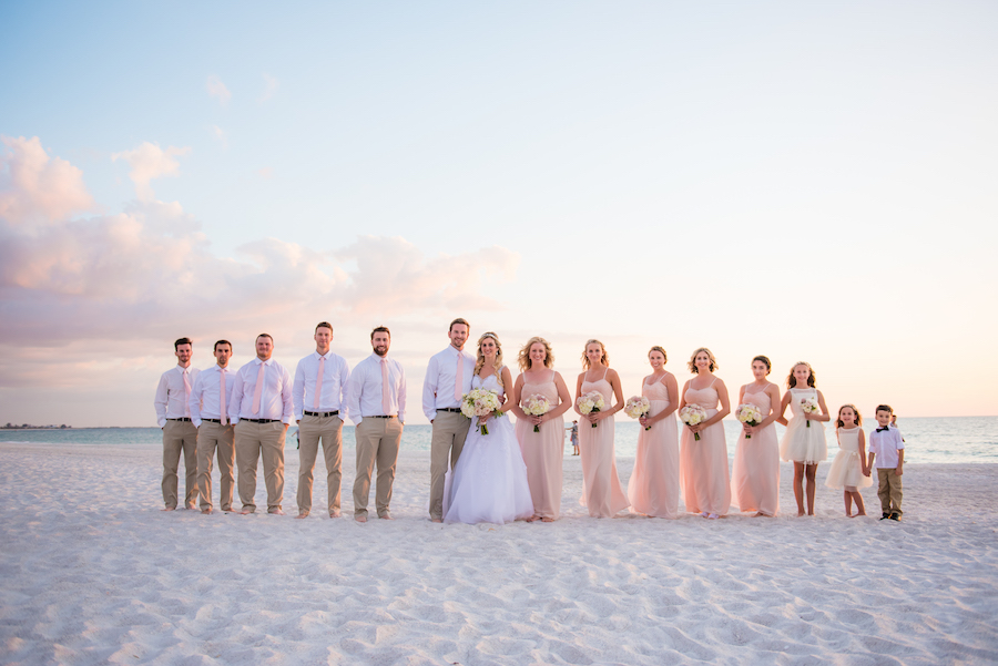 Outdoor St. Pete Beach Bridal Wedding Party Portrait | Blush Pink David's Bridal Bridesmaids Dresses with White Tulle Wedding Dresses and Groomsmen in Khaki Pants with White Button Down Shirts with Pink Ties | Tampa Wedding Photographer Kera Photography